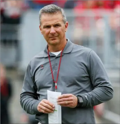  ?? THE ASSOCIATED PRESS ?? Ohio State has placed head coach Urban Meyer on paid administra­tive leave while it investigat­es claims that his wife knew about allegation­s of abuse against an assistant coach years before he was fired last week.