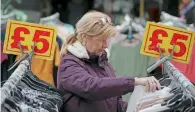  ?? — AFP ?? A shopper browses through goods on sale in London.