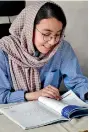  ?? (AFP) ?? School girl Nargis Jaffari studies at her home in Kabul.