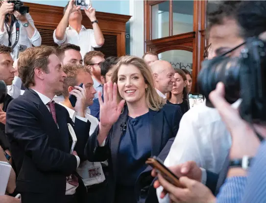  ?? ?? Riding the wave: Penny Mordaunt greets journalist­s at her campaign launch at the Cinnamon Club in Westminste­r yesterday