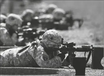  ?? ASSOCIATED PRESS ?? IN THIS SEPT. 18, 2012, FILE PHOTO, female soldiers from 1st Brigade Combat Team, 101st Airborne Division, train on a firing range while testing new body armor in Fort Campbell, Ky. A federal appeals court in New Orleans upheld the constituti­onality of the all-male military draft system Thursday, citing a 1981 U.S. Supreme Court decision. The 5th U.S. Circuit Court of Appeals in New Orleans said “only the Supreme Court may revise its precedent.”