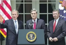  ?? Emilie Sommer AFP/Getty Images ?? PRESIDENT George W. Bush nominated Mueller, center, as FBI director in 2001. The Sept. 11 attacks would come just a week after Mueller’s first day on the job.