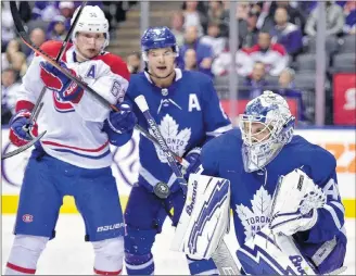  ?? CP PHOTO ?? Toronto Maple Leafs goaltender Garret Sparks (40) makes a save as Leafs defenceman Connor Carrick (8) ties up Montreal Canadiens left winger Artturi Lehkonen (62) during third-period NHL preseason action in Toronto recently.