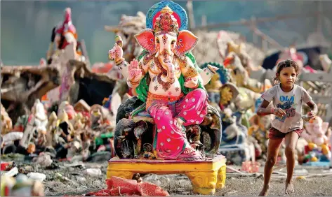  ?? REUTERS ?? A child plays beside an idol of Lord Ganesh, the day after it was immersed in the Yamuna river for the Ganesh Chaturthi festival in Delhi on Wednesday.