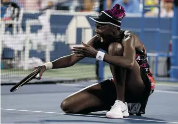  ?? MATTHEW STOCKMAN/GETTY IMAGES ?? Venus Williams of the United States slips on the wet court during her second-round match against Zheng Jie of China Wednesday in New York City. Williams lost 6-3, 2-6, 7-6 (5).