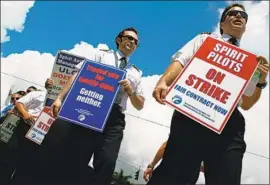  ?? Joe Raedle Getty Images ?? PILOTS for the carrier on strike in 2010. Only three years ago, Spirit had the industry’s worst on-time arrival rate and among the highest rates of lost luggage.