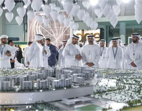  ?? Victor Besa / The National ?? Sheikh Hamed bin Zayed visits Aldar’s model for Alghadeer, under glass balloons that rise and fall to music