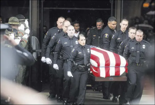  ?? Noah Berger The Associated Press ?? Newman police officers carry the body of their slain colleague Cpl. Ronil “Ron” Singh during his funeral Saturday in Modesto, Calif. Prosecutor­s have charged Gustavo Perez Arriaga, who was in the United States illegally, with Singh’s killing.