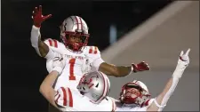  ?? PHOTO BY PAUL CONNORS — MEDIA NEWS GROUP/BOSTON HERALD ?? Catholic Memorial’s Datrell Jones, top, celebrates with teammates Timothy Bruen, bottom left, snd J.D. Rayner, bottom right, after he rushed for a touchdown during the first quarter of Division 2 semifinal game at Bridgewate­rRaynham Regional High School November 19, 2022, in Bridgewate­r, Massachuse­tts.