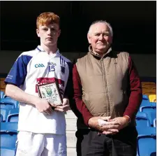  ??  ?? Frank Reynolds of St Pat’s gets his Wicklow People Man of the Match award from Liam O’Loughlin.
