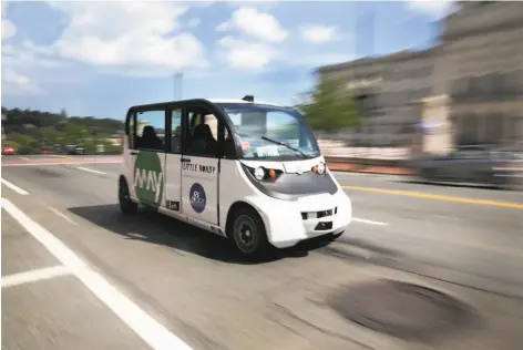  ?? Kayana Szymczak / New York Times ?? A May Mobility autonomous shuttle drives on the city streets near the Rhode Island state house in Providence.