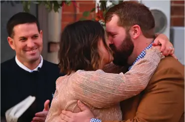  ?? Staff photo by Hunt Mercier ?? ■ Samantha Whitlow kisses her husband, Jonathan Stokes, Friday after they were announced husband and wife at their wedding ceremony at Kress Gap in downtown Texarkana, Texas.