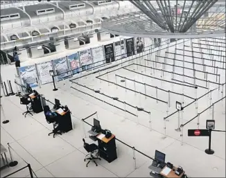  ?? SPENCER PLATT Getty Images ?? AN EMPTY departure terminal at John F. Kennedy Internatio­nal Airport in New York City ref lects the global travel slowdown over the coronaviru­s pandemic.