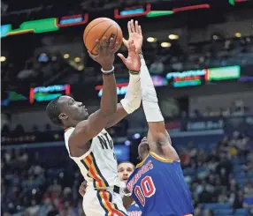  ?? AP ?? Pelicans guard Jared Harper goes to the basket against Warriors forward Jonathan Kuminga on Sunday in New Orleans.