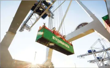 ?? ASSOCIATED PRESS ?? IN THIS JUNE 19 PHOTO, A SHIP TO SHORE CRANE lifts a 40-foot Evergreen Line shipping container off a jockey truck onto a container ship at the Port of Savannah in Savannah, Ga.