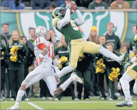  ?? DAVID ZALUBOWSKI/THE ASSOCIATED PRESS ?? Colorado State defensive back Tyree Simmons, right, intercepts a pass in front of UNM’s Ridge Jones during the Rams’ 58-20 rout in Fort Collins.