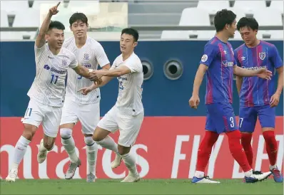  ?? (AFP) ?? Shanghai Shenhua’s midfielder Yu Hanchao (left) celebrates his goal during the AFC Champions League Group F match against at the Education City Stadium on Tuesday. The two sides will clash again on Friday at 4pm.