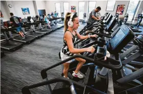  ?? Brett Coomer / Houston Chronicle ?? Avery Stubbins works out on a stair-climbing machine at VillaSport. VillaSport has a location in The Woodlands and plans to open another in Katy.