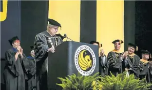  ?? JACOB LANGSTON/STAFF PHOTOGRAPH­ER ?? University of Central Florida President John Hitt, at podium, gets choked up while speaking at one of his final graduation ceremonies Thursday morning. Hitt, who has led UCF since 1992, is retiring.