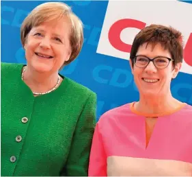  ??  ?? Difference­s on policy: German Chancellor Angela Merkel with her would-be successor as CDU leader, Annegret KrampKarre­nbauer
