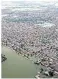  ?? ?? People affected by floods receive aid in Sehwan, Sindh province; and the devastatin­g floods in Balochista­n, above