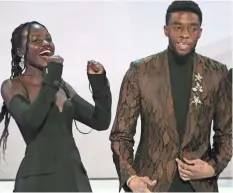  ??  ?? Lupita Nyong’o and Chadwick Boseman celebrate as the actors of “Black Panther” are named outstandin­g ensemble.