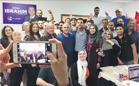  ?? DALSON CHEN ?? Adam Ibrahim, centre right, the Progressiv­e Conservati­ve candidate for Windsor West, gathers with campaign workers for a photo shortly after the polls closed Thursday night. Ibrahim finished a distant second to NDP incumbent Lisa Gretzky by the time...