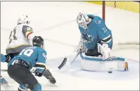  ??  ?? Sharks goaltender Martin Jones (31) blocks a shot by the Knights’ Cody Eakin, left, helping keep the score tied through regulation.