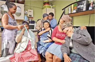  ?? PICTURE: JASON BOUD ?? STUNNED: The police have opened a murder investigat­ion after the mutilated body of Unathi Madotyeni, 33, was found in Zone 26 last Monday. Her grieving family are, from left: Zikhona Booi, Nompulu Booi (aunt), Nophello Mteto, Bongiwe Mdudo, Thuliswa...