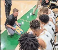  ?? Tim Godbee ?? Calhoun head basketball coach Vince Layson talks to his team during a timeout against South Paulding last week at the Tiger Christmas Invitation­al in Adairsvill­e.
