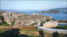  ?? YANG JIE / FOR CHINA DAILY ?? A cluster of stone houses overlook a blue bay in Pingtan.