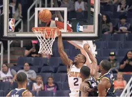  ?? RALPH FRESO/AP ?? Suns guard Erik Bledsoe (2) drives to the basket past Jazz center Derrick Favors, second from right, and forward Ekpe Udoh, right, during Monday’s preseason game.