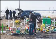  ?? CP PHOTO ?? People visit a memorial at the intersecti­on of a fatal bus crash that killed 16 members of the Humboldt Broncos hockey team last week near Tisdale, Sask. Saturday.