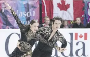  ?? PAUL CHIASSON/THE CANADIAN PRESS ?? Tessa Virtue and Scott Moir are first after the short dance Friday at Skate Canada Internatio­nal in Regina.