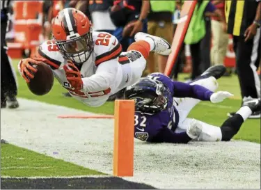  ?? GAIL BURTON — THE ASSOCIATED PRESS ?? Duke Johnson (29) is stopped just short of a touchdown by Ravens free safety Eric Weddle (32) during the 2017 season.