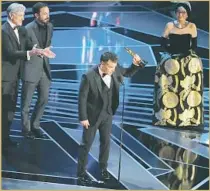  ?? Robert Gauthier Los Angeles Times ?? WRITER-DIRECTOR Sebastián Lelio accepts the Oscar for foreign-language film for Chile’s “A Fantastic Woman.”