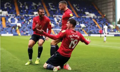  ??  ?? Liam McAlinden of Morecambe celebrates with Aaron Wildig (left) and Sam Lavelle after scoring his side’s second goal during the League Two play-off semi-final first leg at Prenton Park. Photograph: Lewis Storey/Getty Images