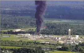  ?? THE ASSOCIATED PRESS ?? Thick black smoke and towering orange flames shot up Friday from the flooded Houstonare­a chemical plant after two trailers of highly unstable compounds blew up a day earlier after losing refrigerat­ion.