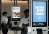  ?? NAM Y. HUH — THE ASSOCIATED PRESS FILE ?? Employees stand in McDonald’s Chicago flagship restaurant.