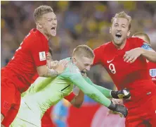  ?? AP PHOTO ?? KICK IT OFF: England’s Kieran Trippier (left), goalkeeper Jordan Pickford (center) and Harry Kane celebrate yesterday’s World Cup victory against Colombia.