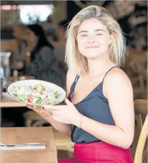 ?? Photo / Jason Oxenham ?? Sarah Pollok enjoys a caesar salad at The Butcher’s Son.