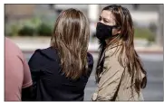  ?? HANS GUTKNECHT — STAFF PHOTOGRAPH­ER ?? Pedestrian­s wear masks in Los Angeles on Wednesday. Citing continued downward trends in COVID-19 cases and hospitaliz­ations, county Department of Public Health officials scrubbed plans to reimpose a universal indoor mask-wearing mandate.