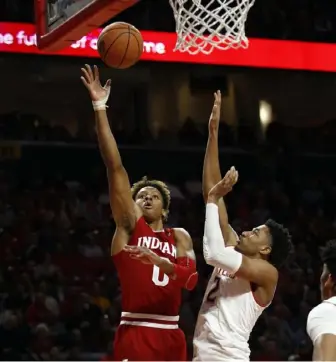  ?? Associated Press ?? Indiana guard Romeo Langford, left, shoots over Maryland guard Aaron Wiggins in the first half Friday in College Park, Md. The Terrapins won, 78-75.