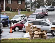  ?? MARK MORAN/THE CITIZENS’ VOICE VIA AP ?? Vehicles are lined around the block at a food distributi­on event at the Jenkins Township Fire Department station, Jenkins Township, Pa., Friday April 3. during which several hundred people were served food packages.