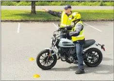  ?? — HIGH GEAR MOTORCYCLE TRAINING ?? Desmond Rodenbour instructs a student at Spanish Banks in Vancouver.