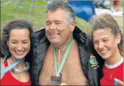  ??  ?? AIR SUPPORT: Peter Moore with his swim assistants, paramedic students Nikita Werthmann, left, and Simone Theunissen