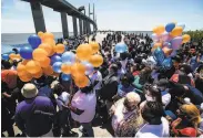  ?? Sean Rayford / Getty Images ?? Protesters gather Saturday in Brunswick, Ga., to honor Ahmaud Arbery near where he was killed.