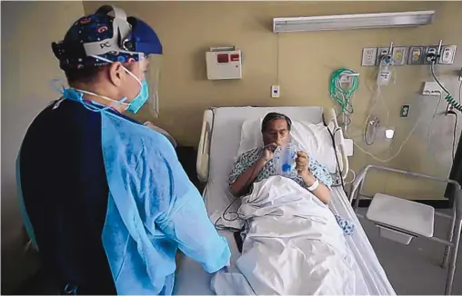  ?? MARK LAMBIE/EL PASO TIMES ?? Registered nurse Daniel Corral works with a COVID-19 patient at the El Paso Long Term Acute Care Hospital earlier this month.