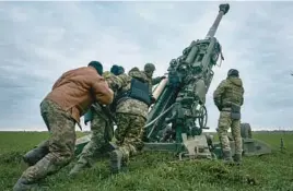  ?? LIBKOS ?? Ukrainian soldiers prepare to fire an M777 howitzer at Russian positions this week in Ukraine’s Kherson region. Ukraine will soon get Patriot missiles, also supplied by the U.S.