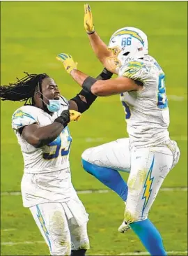  ?? Jeff Bottari Associated Press ?? DEFENSIVE TACKLE Justin Jones, left, and tight end Hunter Henry exult after the Chargers ended a nine- game losing streak against AFC West opponents.